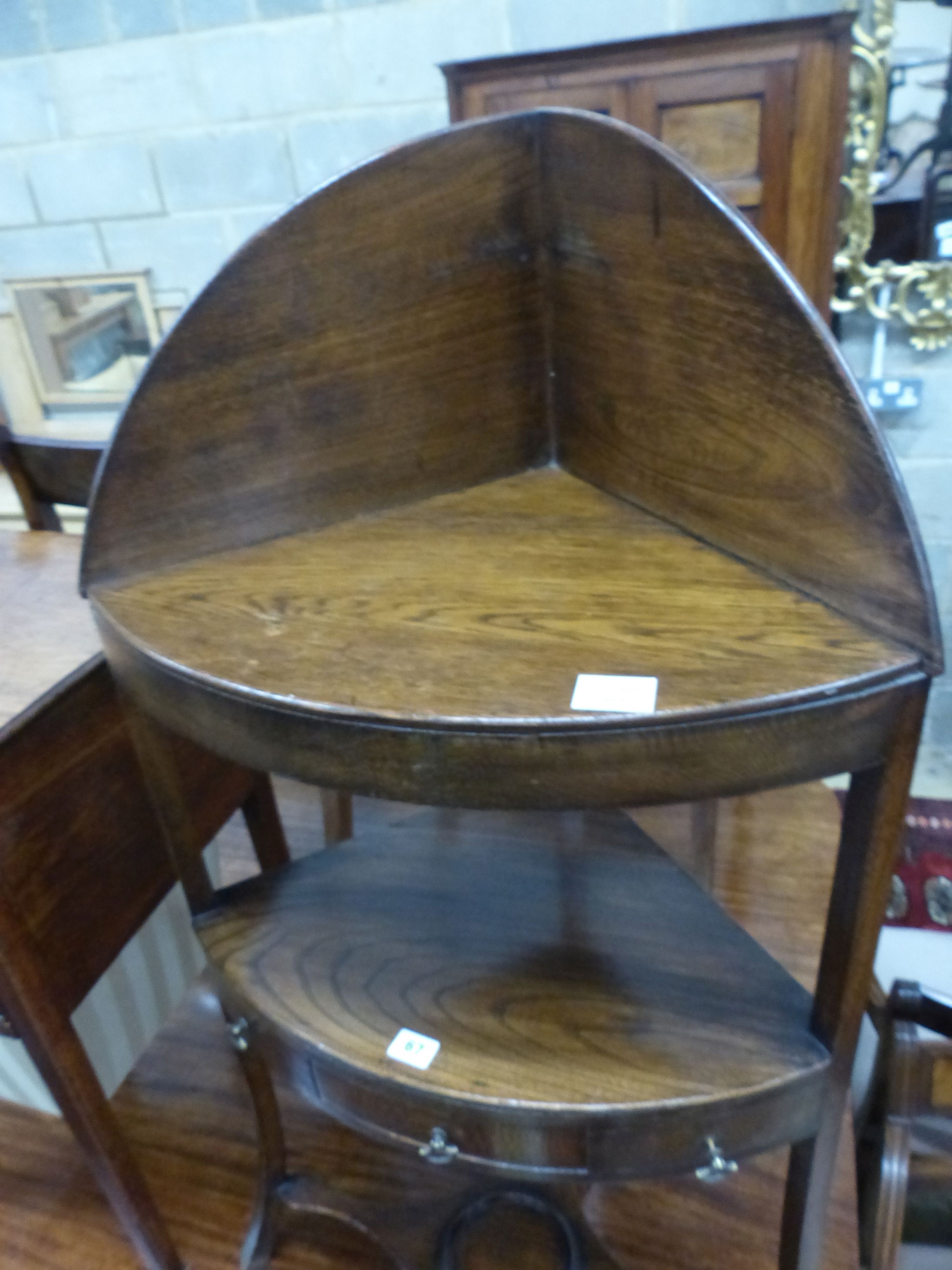 A George III oak and elm three tier corner washstand, W.56cm D.39cm H.110cm